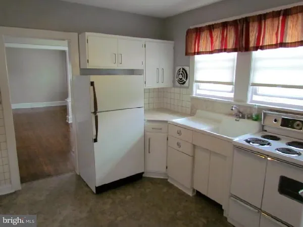 a kitchen with appliances cabinets and a sink
