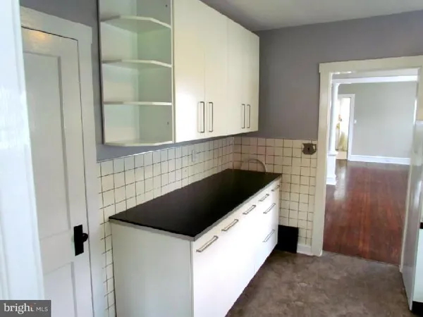 a kitchen with a sink and a refrigerator