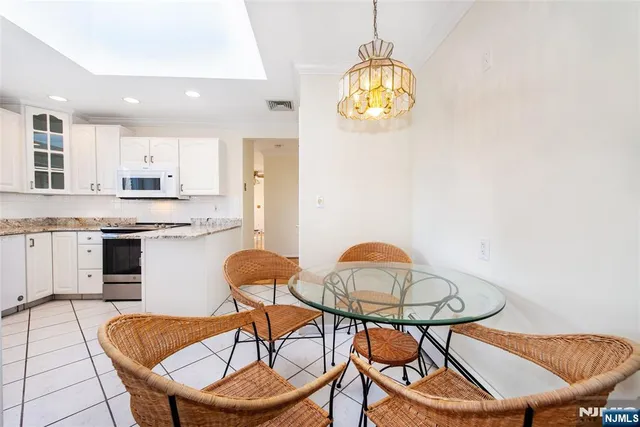 a view of a dining room with furniture and chandelier