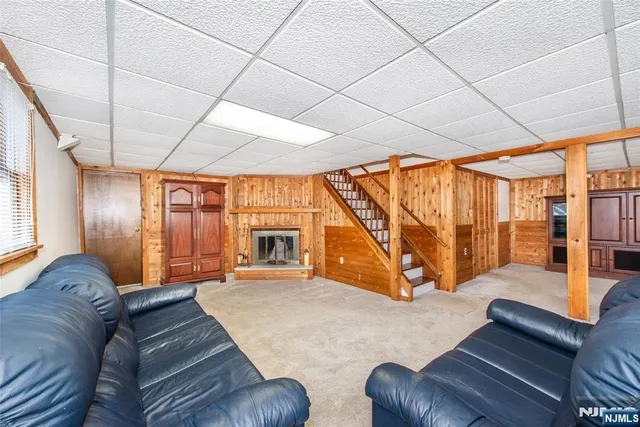 a living room with furniture a large window with outer view and couch