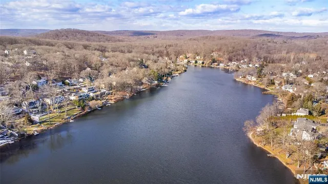 an aerial view of a houses with city view and lake view
