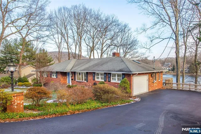 a front view of a house with a yard and a garage