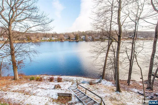 a wooden bench sitting next to a lake