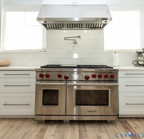 a stove top oven sitting inside of a kitchen