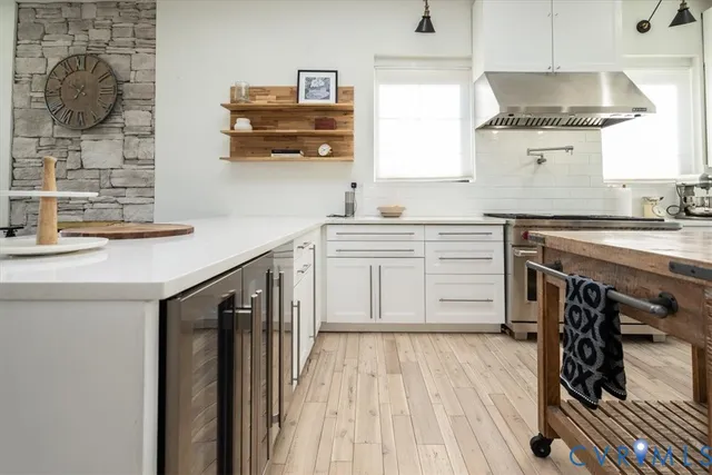 a kitchen with cabinets and wooden floor