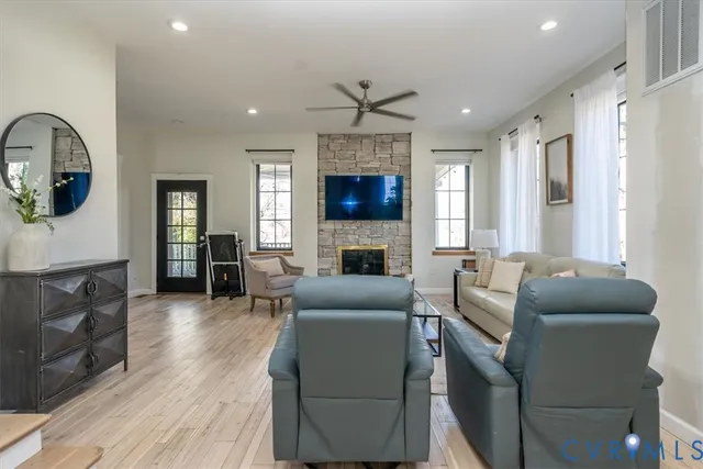 a living room with furniture a fireplace and a flat screen tv
