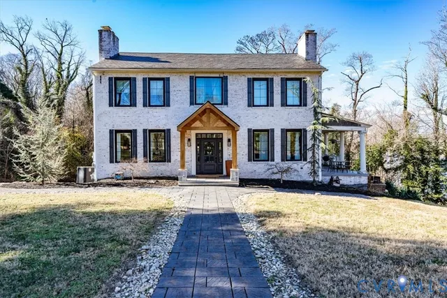 a front view of a house with yard porch and furniture