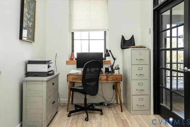 a view of a workspace with furniture and a window