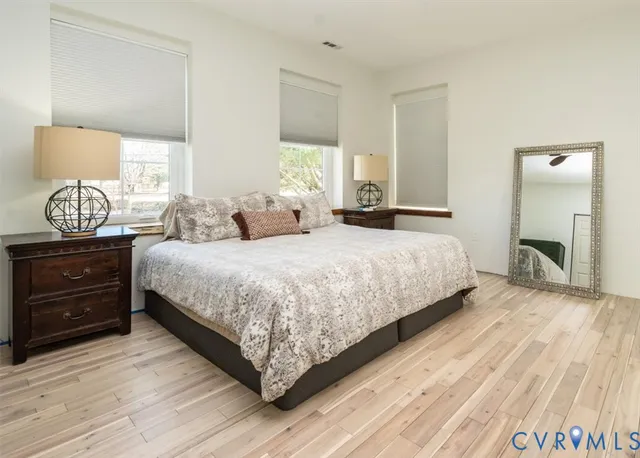 a bedroom with a bed and wooden floor