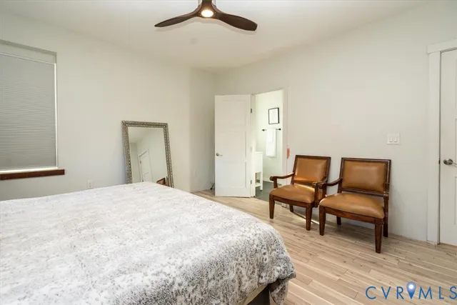 a spacious bedroom with a bed and a chair