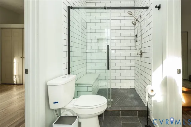 a bathroom with a toilet and a shower
