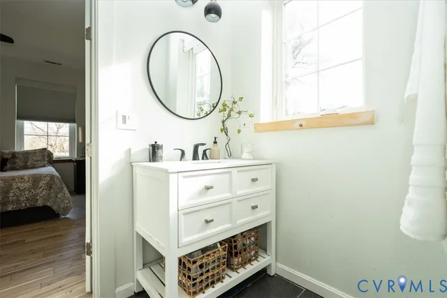 a bathroom with a sink mirror and vanity