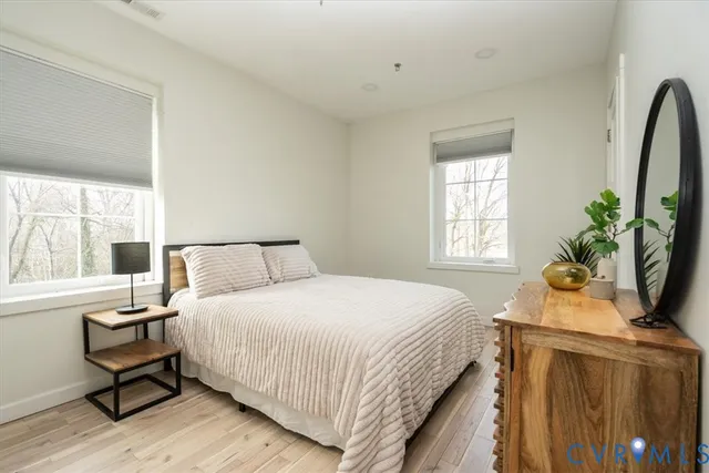 a bedroom with a bed and a window