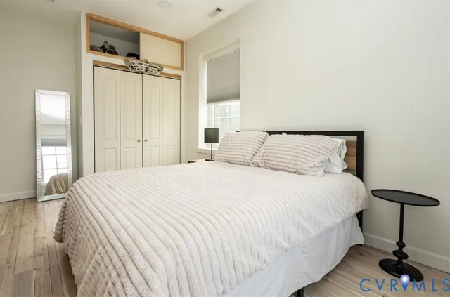 a bedroom with a bed and a mirror