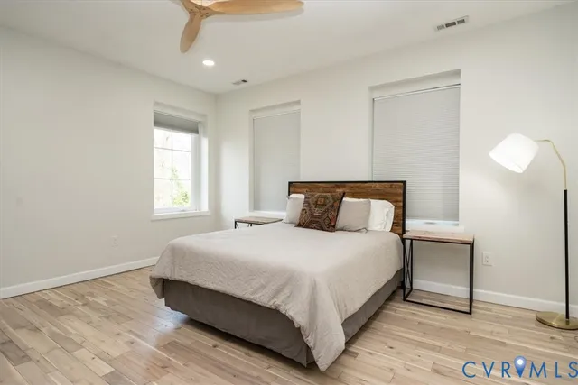 a bedroom with a bed and a night stand