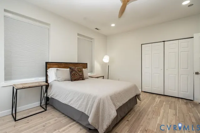 a bedroom with a bed and wooden floor