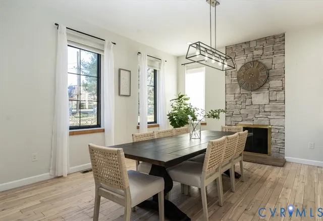 a dining room with furniture a chandelier and wooden floor