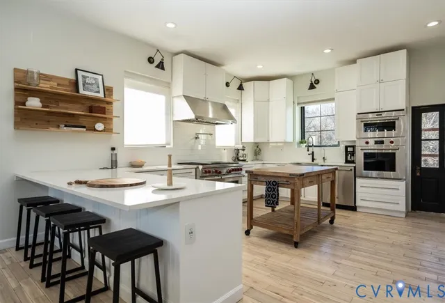 a kitchen with appliances a sink and cabinets