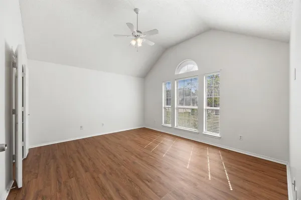 wooden floor in an empty room with a window