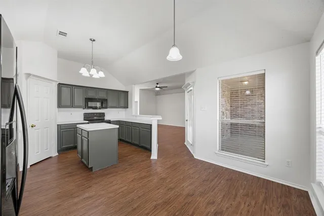 a kitchen with a refrigerator and a sink
