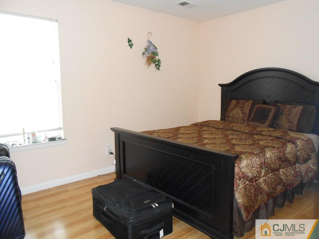 49 Rainford Road Edison, NJ 08820 - Photo 3 of 17 a bed sitting in a bedroom next to a window
