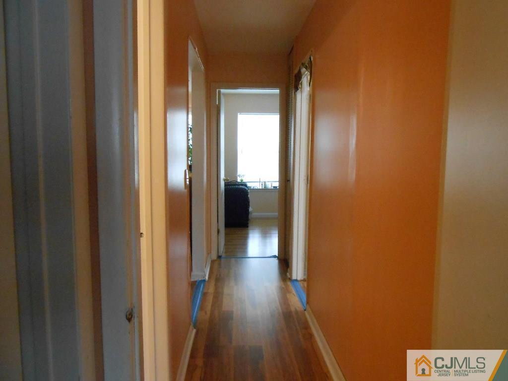 49 Rainford Road Edison, NJ 08820 - Photo 5 of 17 a view of a hallway with wooden floor