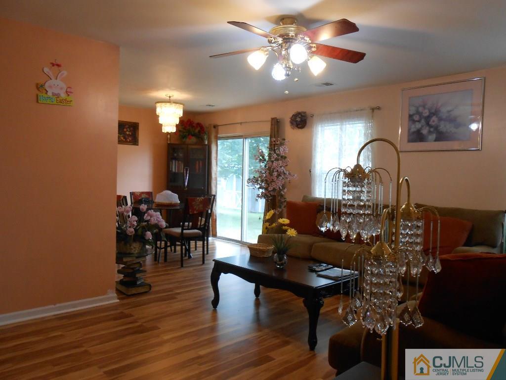 49 Rainford Road Edison, NJ 08820 - Photo 8 of 17 a living room with fireplace furniture and a chandelier