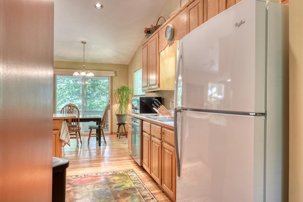 171 Mountain Top Road Blairsville, GA 30512 - Photo 23 of 54 a kitchen with a table chairs refrigerator and cabinets