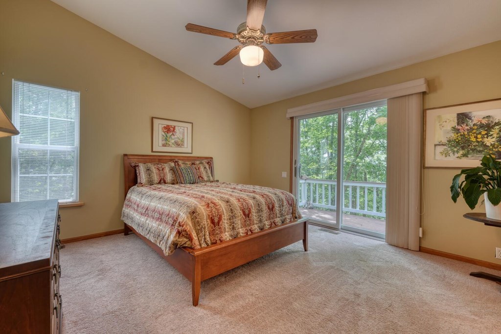 171 Mountain Top Road Blairsville, GA 30512 - Photo 26 of 54 a spacious bedroom with a balcony a bed and a painting on the wall