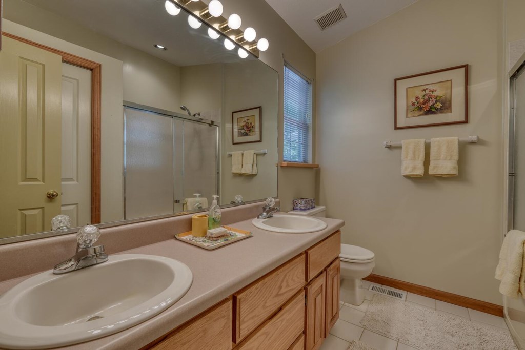 171 Mountain Top Road Blairsville, GA 30512 - Photo 29 of 54 a bathroom with a sink double vanity granite and a mirror