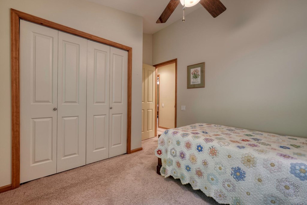 171 Mountain Top Road Blairsville, GA 30512 - Photo 33 of 54 a bedroom with a bed and a chandelier fan