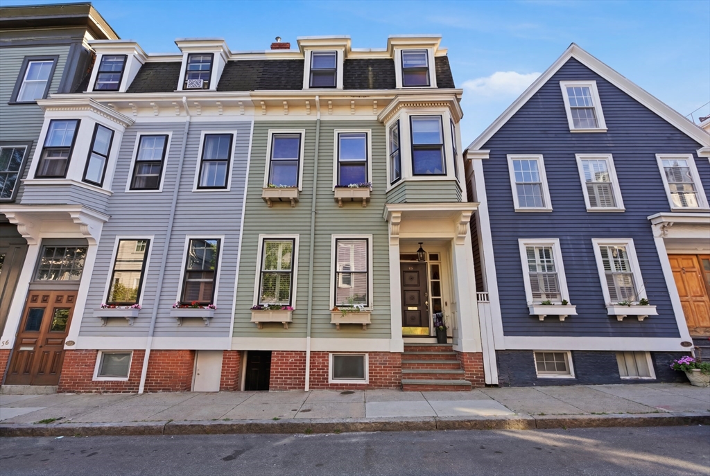 38 Bartlett Street Boston, MA 02129 - Photo 33 of 37 a front view of a building with a yard