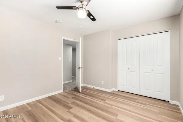 a view of empty room with wooden floor