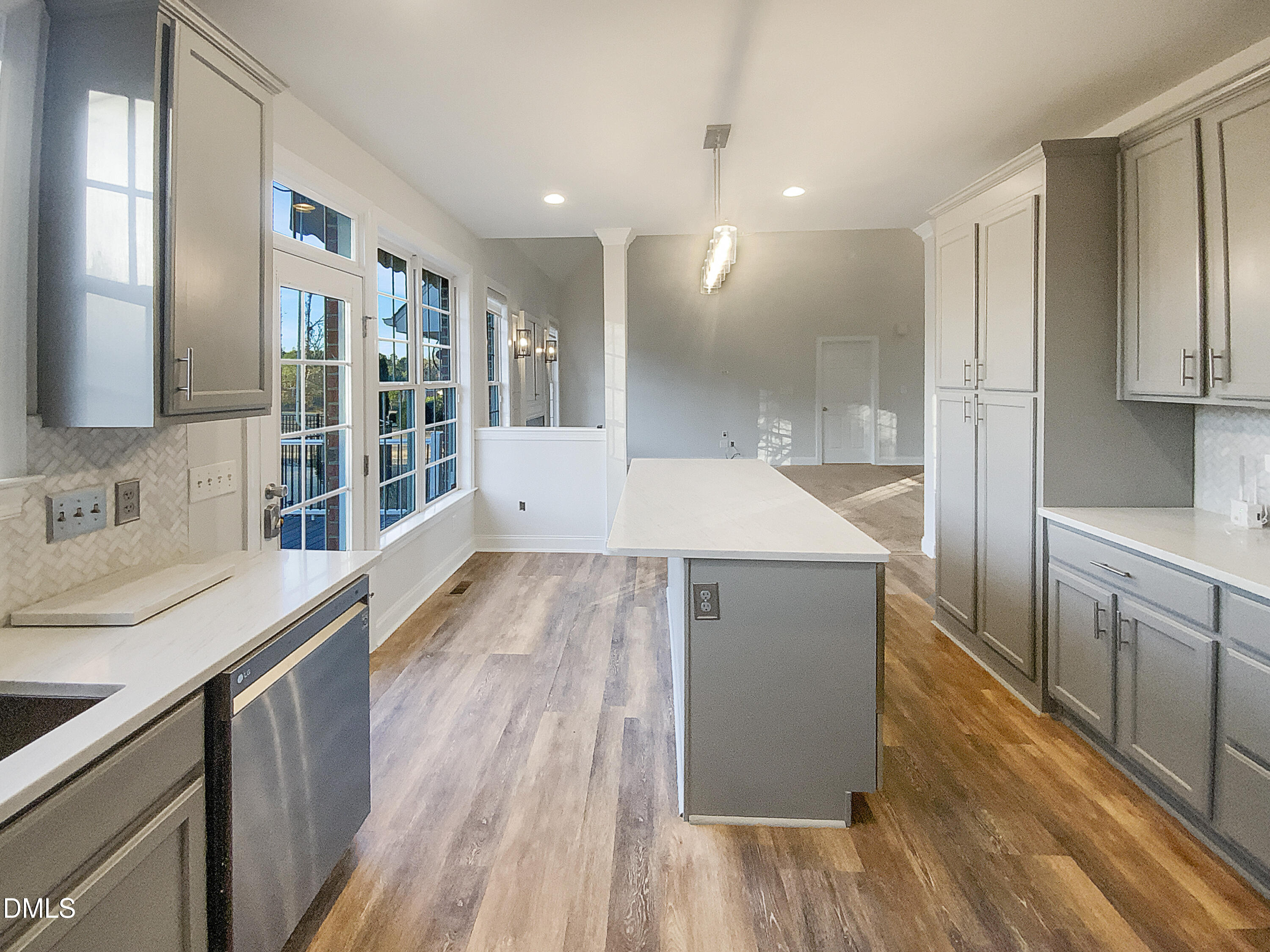 1217 Rolling Farm Drive Raleigh, NC 27603 - Photo 11 of 23 a large kitchen with stainless steel appliances a large counter top a stove and a wooden floors