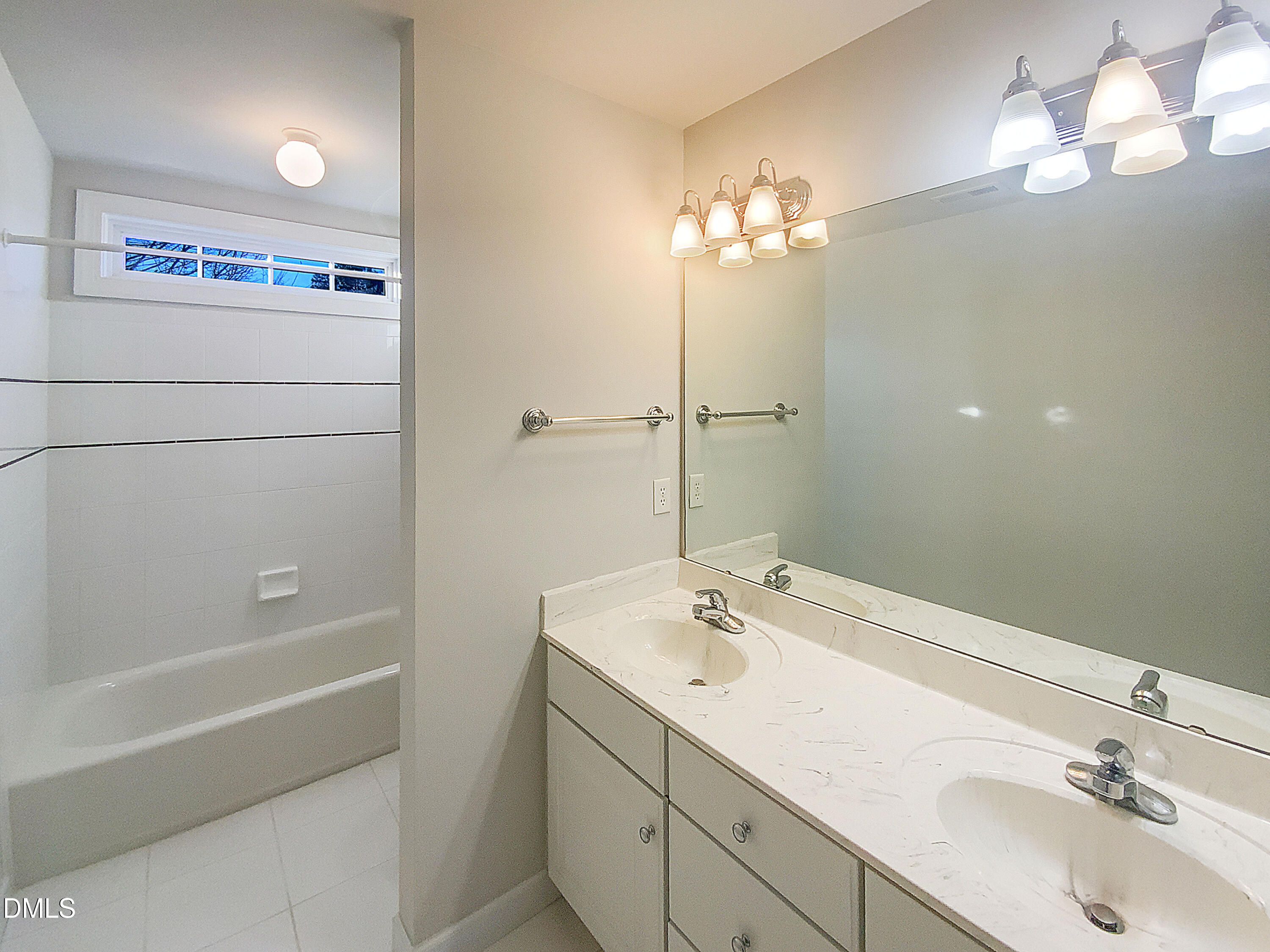 1217 Rolling Farm Drive Raleigh, NC 27603 - Photo 19 of 23 a bathroom with a sink a large mirror and a bathtub