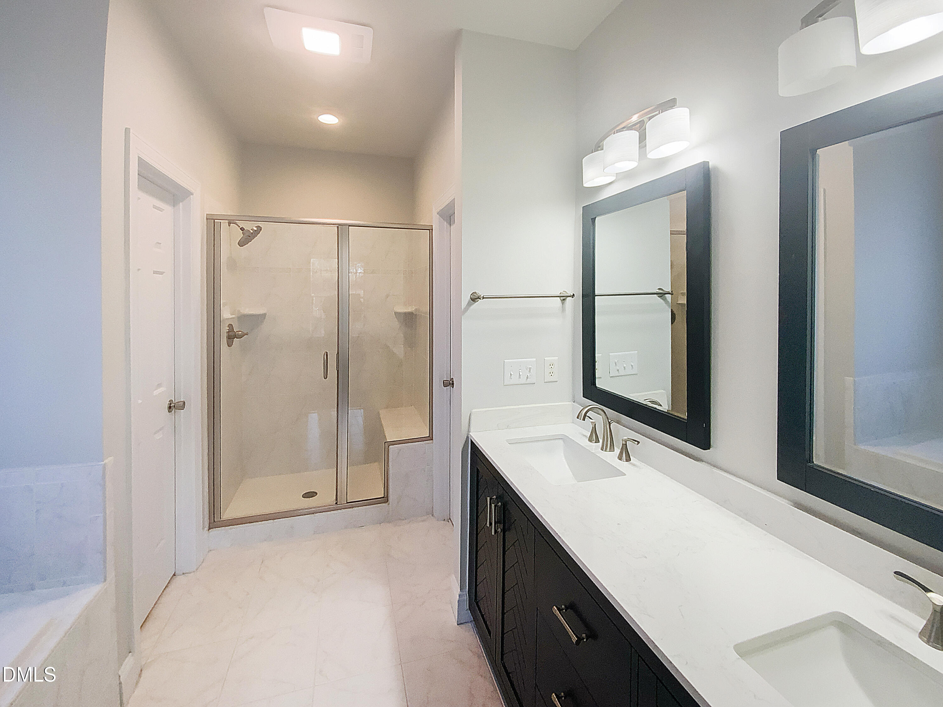 1217 Rolling Farm Drive Raleigh, NC 27603 - Photo 6 of 23 a bathroom with a double vanity sink mirror and shower