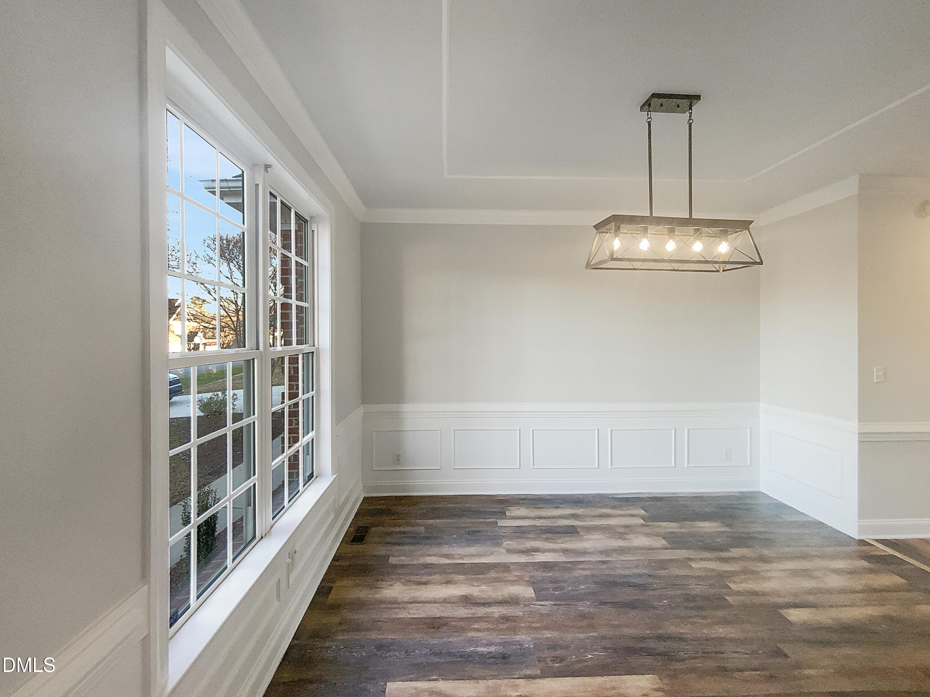 1217 Rolling Farm Drive Raleigh, NC 27603 - Photo 9 of 23 a view of a room with a large window and wooden floor