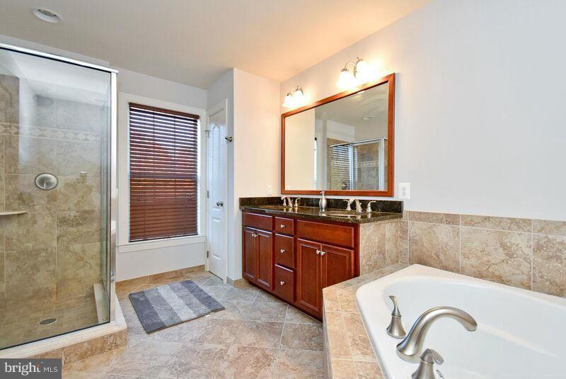 7616 Elmcrest Road Hanover, MD 21076 - Photo 17 of 30 a room with a bed and a dresser