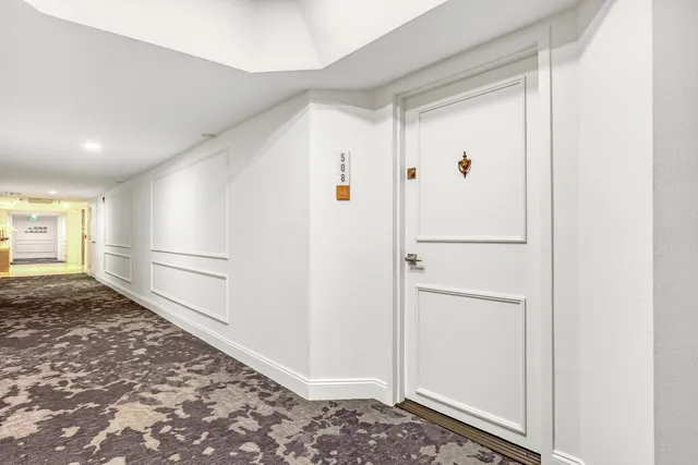 a living room with lots of furniture and a large window