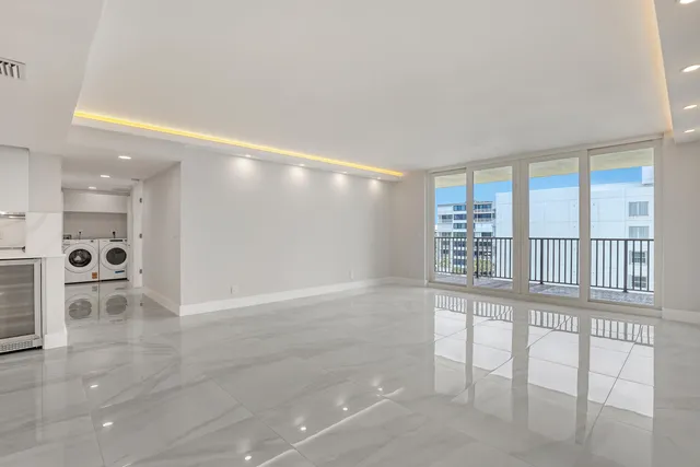 a view of a kitchen with stainless steel appliances a refrigerator and a stove
