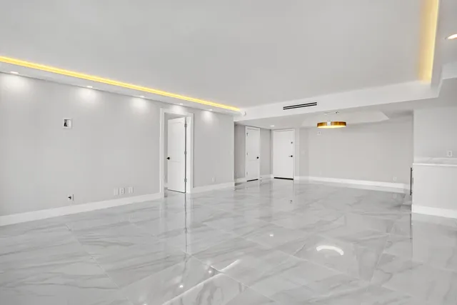 a metallic refrigerator freezer sitting in a kitchen