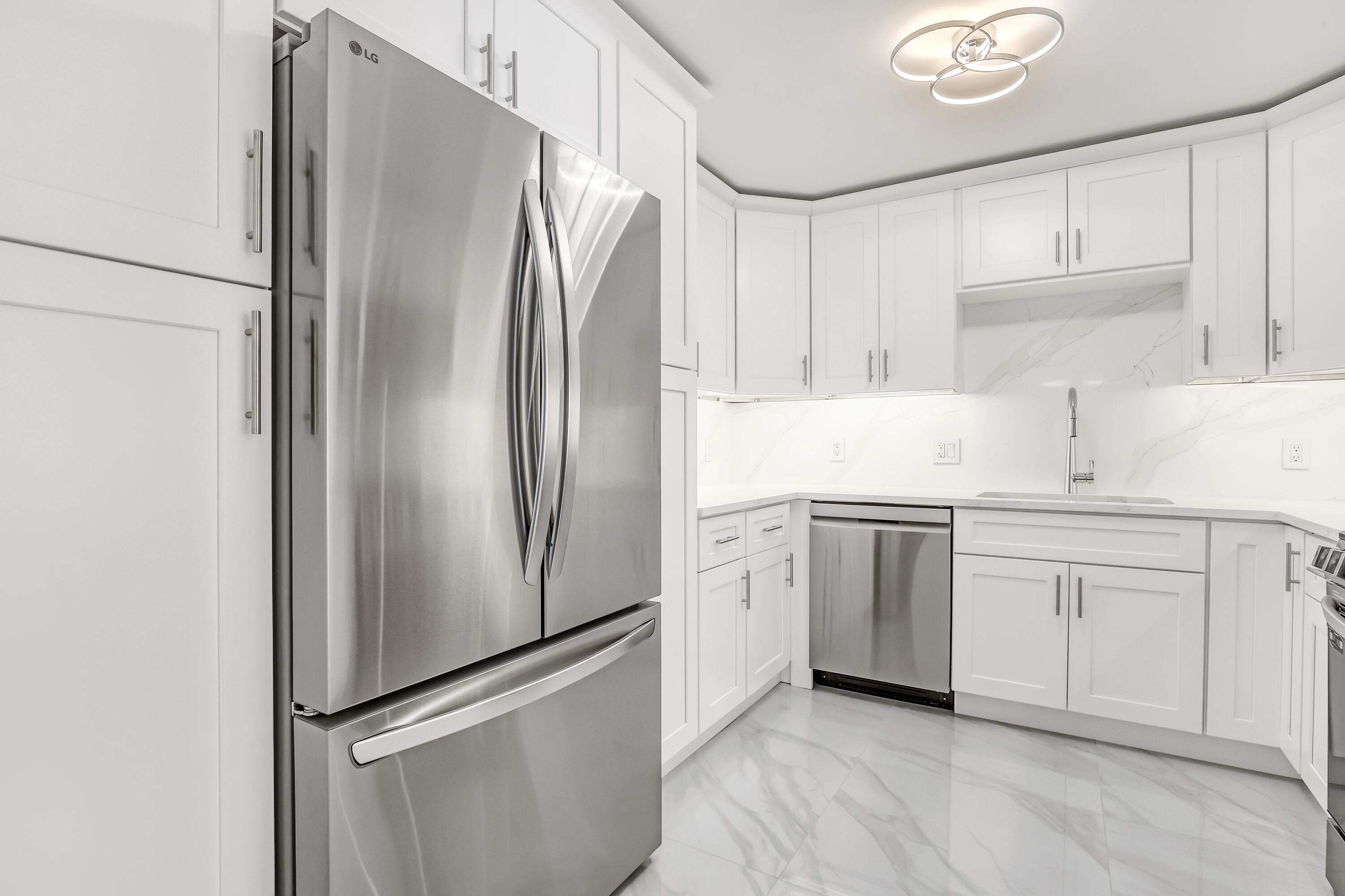 3610 South Ocean Boulevard, Unit 508 South Palm Beach, FL 33480 - Photo 29 of 65 a kitchen with white cabinets and stainless steel appliances