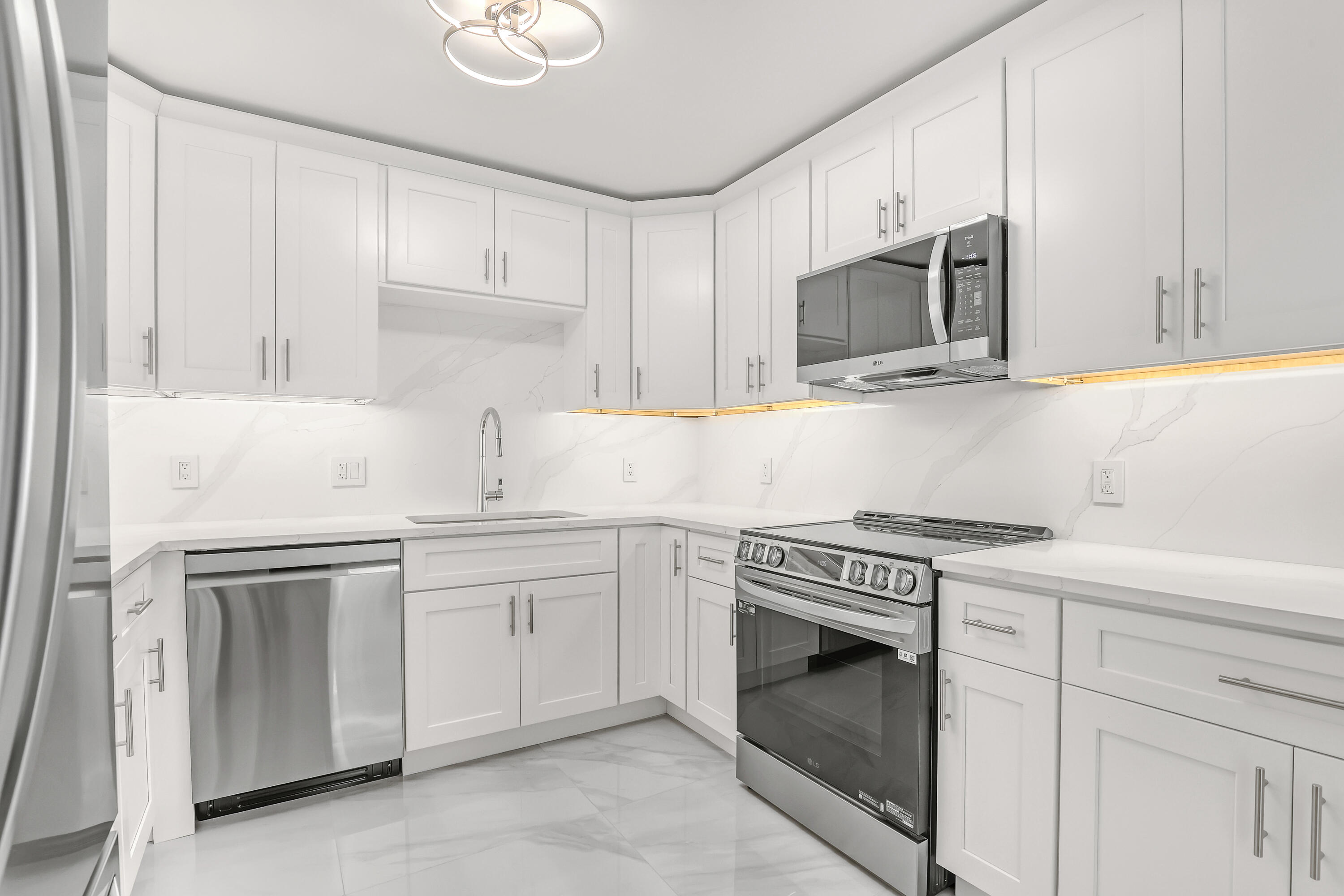 3610 South Ocean Boulevard, Unit 508 South Palm Beach, FL 33480 - Photo 30 of 65 a kitchen with white cabinets and stainless steel appliances