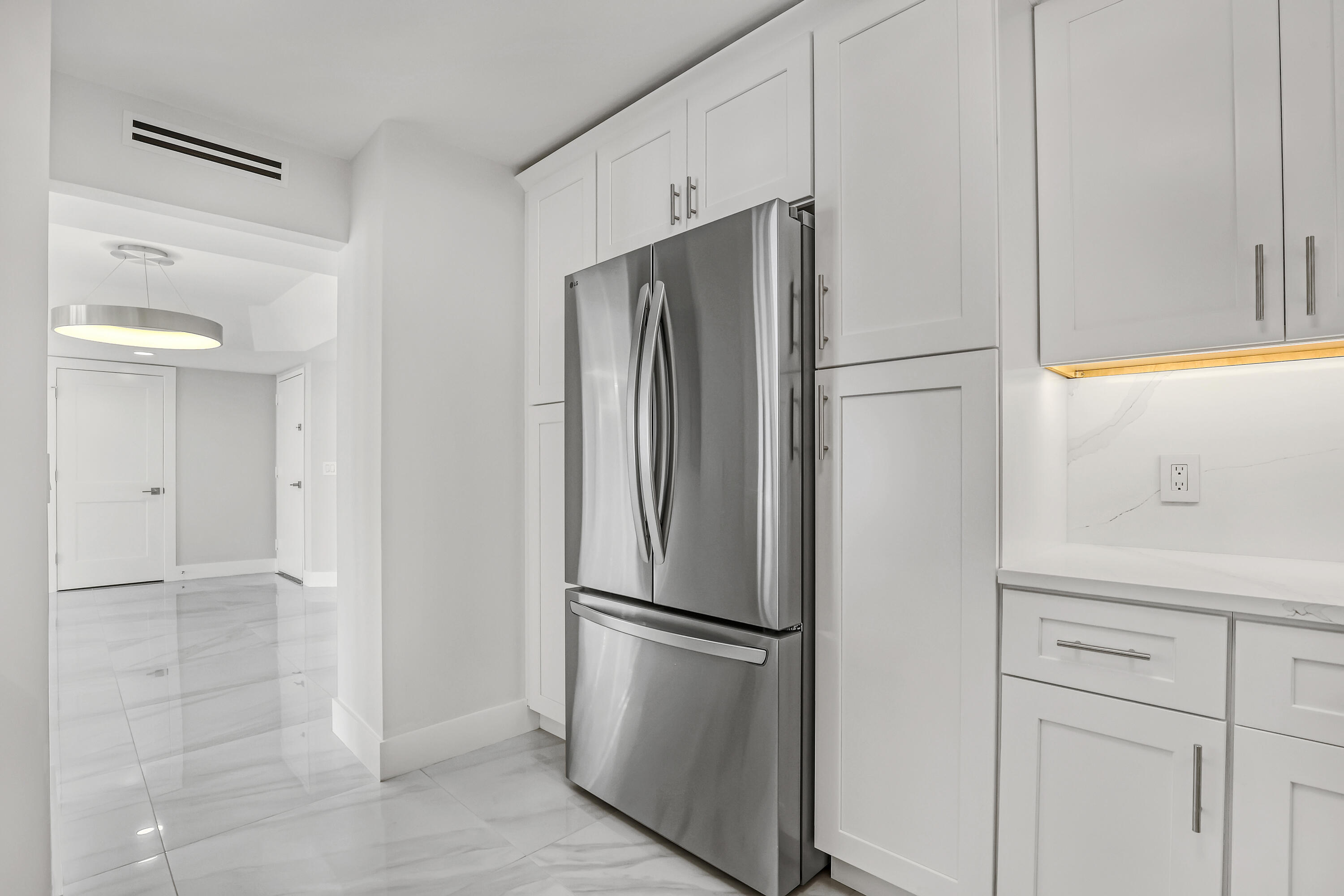 3610 South Ocean Boulevard, Unit 508 South Palm Beach, FL 33480 - Photo 31 of 65 a metallic refrigerator freezer sitting in a kitchen