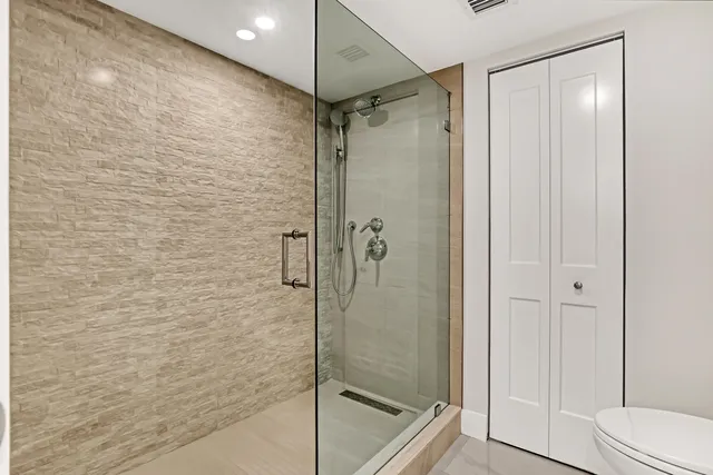 an empty room with closet and wooden floor