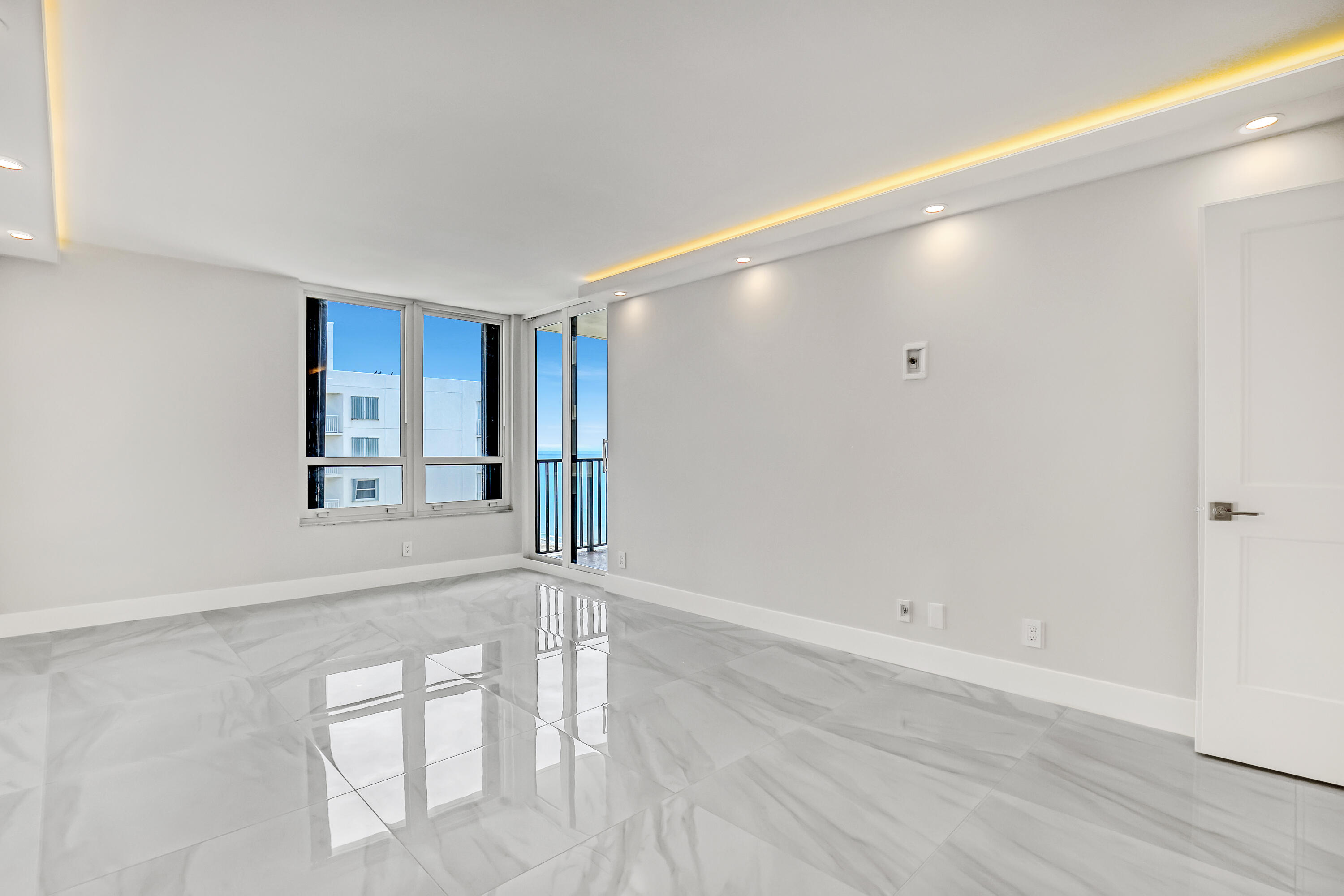 3610 South Ocean Boulevard, Unit 508 South Palm Beach, FL 33480 - Photo 54 of 65 an empty room with wooden floor and windows