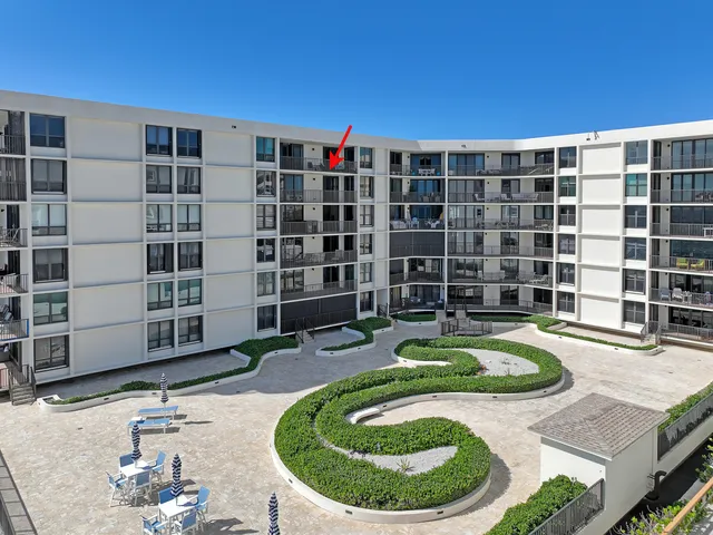 a view of a swimming pool with a lounge chair