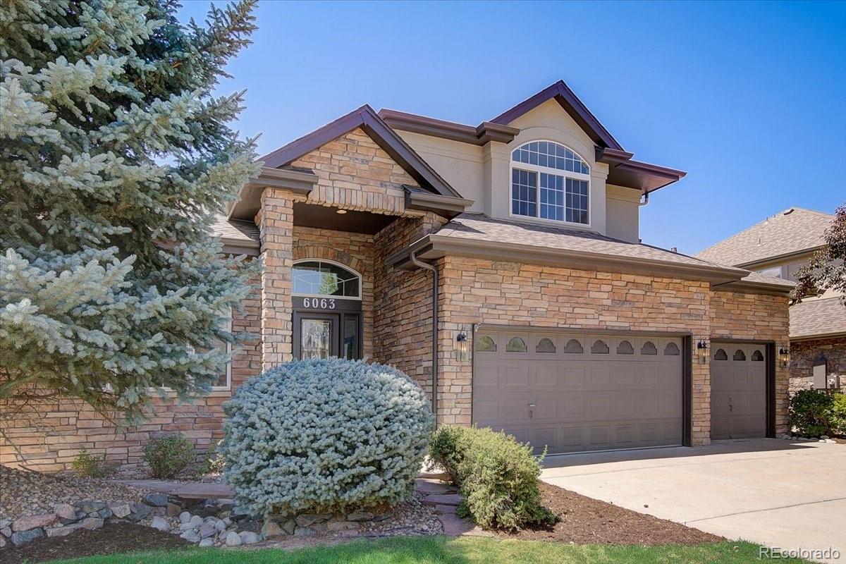 6063 South Eagle Street Centennial, CO 80016 - Photo 1 of 40 a front view of a house with garden