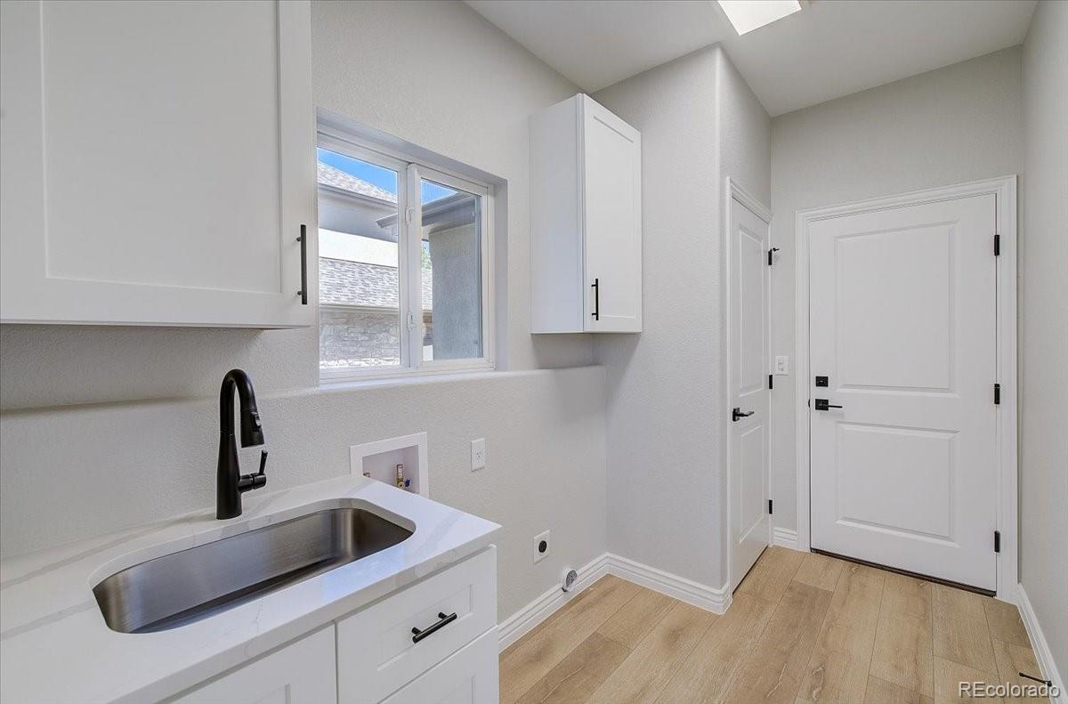 6063 South Eagle Street Centennial, CO 80016 - Photo 16 of 40 a kitchen with a sink and cabinets