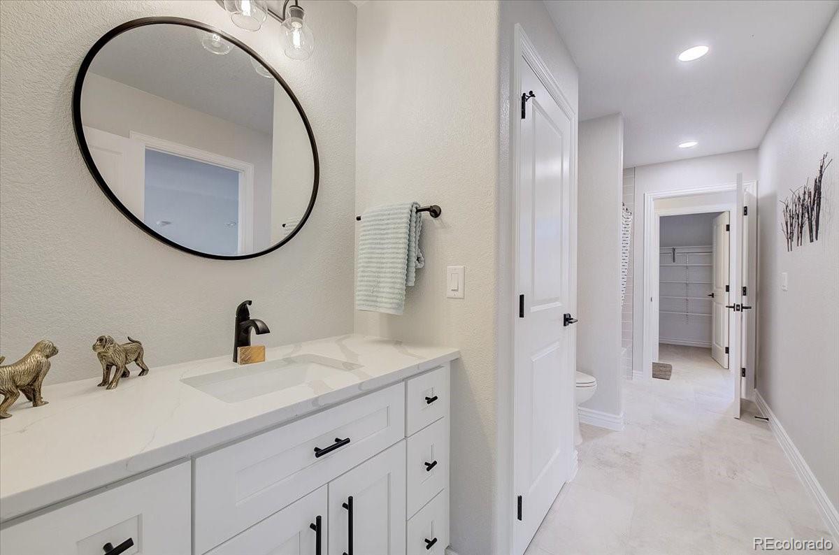 6063 South Eagle Street Centennial, CO 80016 - Photo 17 of 40 a bathroom with a sink and a mirror